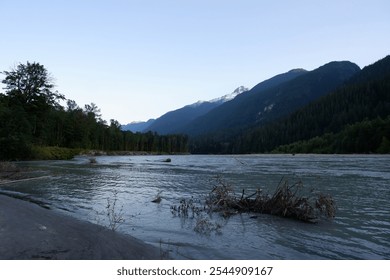 Stunning Aerial View of Squamish Valley at Dusk with Serene River, Sandy Beach, and Majestic Mountain Range Under a Twilight Sky – Squamish, British Columbia, Canada - Powered by Shutterstock