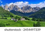 Stunning Alpine scenery of breathtaking Dolomites rocks mountains in Italian Alps, South Tyrol Alto adige , Italy.  Val di Funes and village Santa Maddalena
