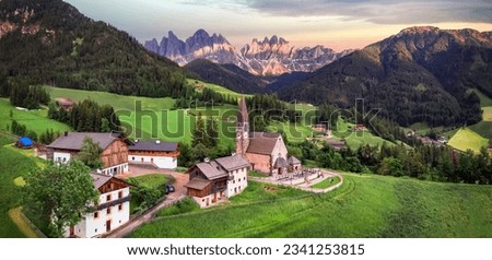 Stunning Alpine scenery of breathtaking Dolomites rocks mountains in Italian Alps, South Tyrol, Italy. Aerial view of Val di Funes and village Santa Maddalena, Valley Isarco