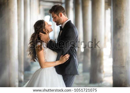 Stunning artistic portrait of bride and groom in love embracing with gorgeous background