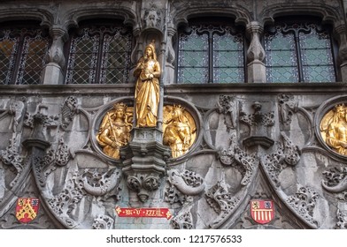 The stunning Basilica of the Holy Blood in Bruges, Belgium. Gothic facade with golden statues of the  Counts of Flanders and beautiful stone ornaments. West Flanders, Europe