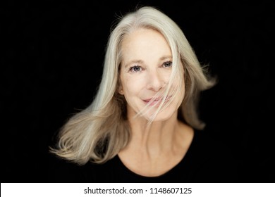 Stunning Beautiful And Self Confident Best Aged Woman With Grey Hair Smiling Into Camera, Portrait With Black Background