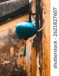 Stunning Blue Lantern Elegantly Hanging From a Charming Old Building in a Historic District.