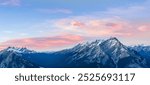 Stunning Canadian Rocky mountains twilight scene of snow capped mountain at Banff National Park in Alberta, Canada. View from Banff Gondola Sulphur Moutain.