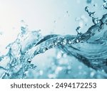 A stunning capture of clear blue water splashing, showcasing the beauty and vitality of moving water droplets. Perfect for advertisements and publications related to nature and purity.