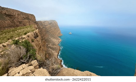Stunning cliffs elegantly meet crystalclear and refreshing ocean waters in a truly picturesque coastal view