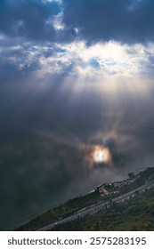 Stunning clouded sky with light ray through cloud, The phenomenon of light passing through gaps in clouds, Tyndall effect, Crepuscular Rays, God rays, Jacob’s ladder, sunlight breaking through cloud