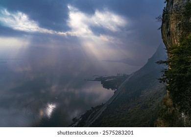 Stunning clouded sky with light ray through cloud, The phenomenon of light passing through gaps in clouds, Tyndall effect, Crepuscular Rays, God rays, Jacob’s ladder, sunlight breaking through cloud