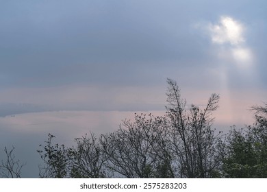 Stunning clouded sky with light ray through cloud, The phenomenon of light passing through gaps in clouds, Tyndall effect, Crepuscular Rays, God rays, Jacob’s ladder, sunlight breaking through cloud