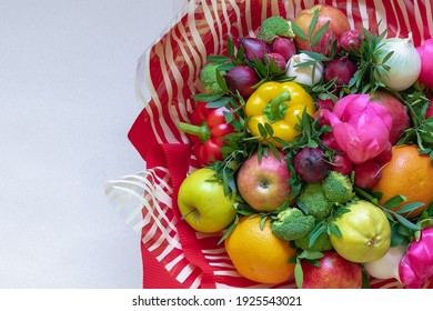 A stunning colorful bouquet of various fresh fruits, vegetables and flowers surrounded by red and transparent with white striped paper on a beige background. Copy space, close up, flat lay - Powered by Shutterstock