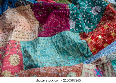 Stunning colourful Indian patchwork quilt with the traditional Kantha running stitch embroidered by hand running from top to bottom - Shutterstock ID 2180587265