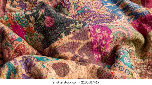 Stunning colourful Indian patchwork quilt with the traditional Kantha running stitch embroidered by hand running from top to bottom - Shutterstock ID 2180587419