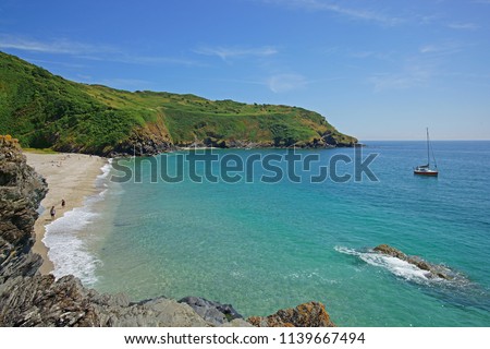 The stunning Cornish beach and coast line of Lantic Bay near Polruan in summer with holiday makers enjoying the sun, Cornwall, England, UK