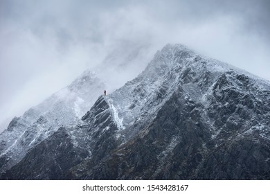 Stunning detail landscape images of snowcapped Pen Yr Ole Wen mountain in Snowdonia during dramatic Winter storm