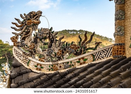 stunning dragon sculpture, adorned with vibrant mosaic tiles, graces rooftop of pagoda as captivating architectural element. intricate details and rich colors