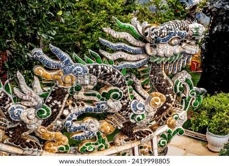 stunning dragon sculpture with vibrant mosaic tiles, graces rooftop of pagoda as captivating architectural element. intricate details and rich colors. adding touch of elegance to sacred structure