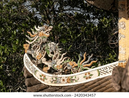 stunning dragon sculpture with vibrant mosaic tiles, graces rooftop of pagoda as captivating architectural element. intricate details and rich colors. adding touch of elegance to sacred structure