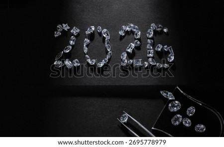 Stunning flat lay composition of the number 2026, carefully formed with natural sparkling diamonds on black background.