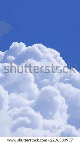 Stunning Fluffy White Cumulus Clouds Floating on Vivid Blue Sunny Sky