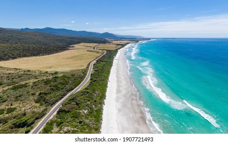 Stunning high angle aerial panoramic drone view of Denison Beach and the A3 Tasman Highway just north of the village of Bicheno on the east coast of Tasmania, Australia on a sunny day.