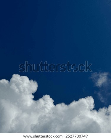 Stunning image of bright white clouds against a deep Yves Klein Blue sky evokes clarity and calm. Ideal for backgrounds, nature themes, or wellness projects, it brings a sense of peace and openness.