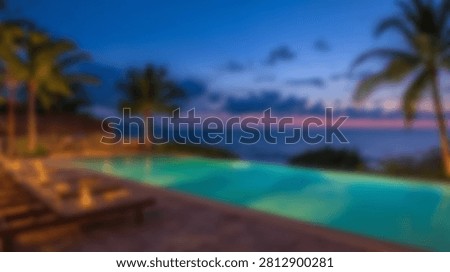 A stunning infinity pool glows with underwater lights, reflecting the twilight sky over a calm ocean, framed by tropical palm trees.