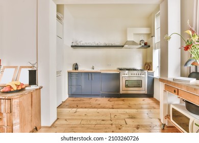 Stunning kitchen with blue kitchen unit and hardwood floor