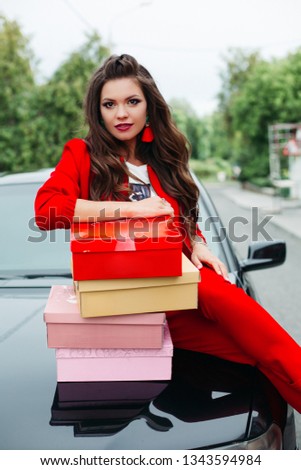 Stunning lady with stack of shoe boxes.