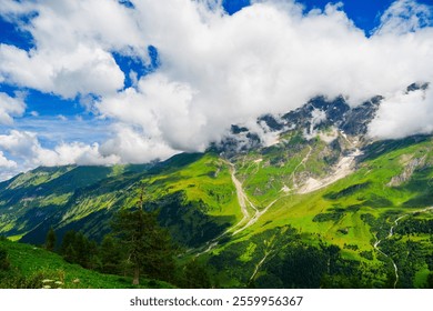 A stunning landscape of the Austrian Alps in Kaprun, featuring an expanse of green fields, rugged mountain peaks, and a pristine river flowing through the valley. - Powered by Shutterstock