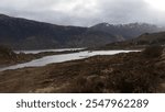 Stunning landscape featuring loch tulla reflecting the cloudy sky near bridge of orchy, showcasing the serene beauty of the scottish highlands