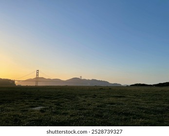 A stunning landscape image of the Golden Gate Bridge at sunset, showcasing the iconic structure bathed in warm, golden light - Powered by Shutterstock