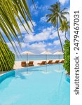 Stunning landscape, swimming pool blue sky clouds. Tropical resort hotel in Maldives. Fantastic relax and peaceful vibes, chairs, loungers under umbrella and palm tree leaves. Luxury travel vacation