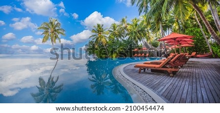Stunning landscape, swimming pool blue sky with clouds. Tropical resort hotel in Maldives. Fantastic relax and peaceful vibes, chairs, loungers under umbrella and palm leaves. Luxury travel vacation