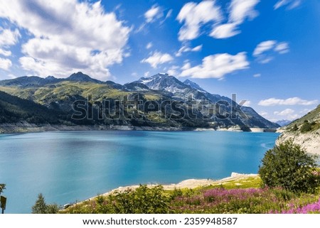 Stunning Landscape of Tignes Lake with Striking Color Contrasts - A breathtaking view of Tignes Lake, where nature paints a vibrant canvas with striking color contrasts. The tranquil waters mirror the