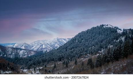 Stunning landscape view of a winter mountain landscape from the Stewart Falls hike. A snowy rocky mountain covered in Pine trees with a winter sunset on a cold December evening in Provo, Utah. - Shutterstock ID 2007267824