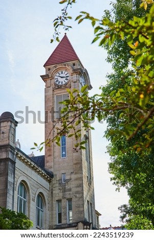 Stunning limestone clock tower on college campus in Bloomington