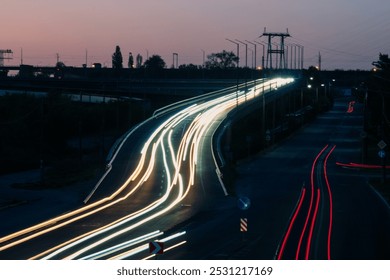 Stunning long exposure photograph of nighttime traffic generates vibrant light trails along a busy highway - Powered by Shutterstock