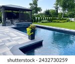 Stunning luxury backyard view of pool with sundeck, chaise lounges, garden, pergola   Modern and sleek, it has an effortless boho inspired, resort like feel. Inspired by Tulum, Mexico