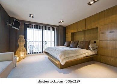stunning luxury bedroom with a king size bed, wall mount plasma tv, sofa ...