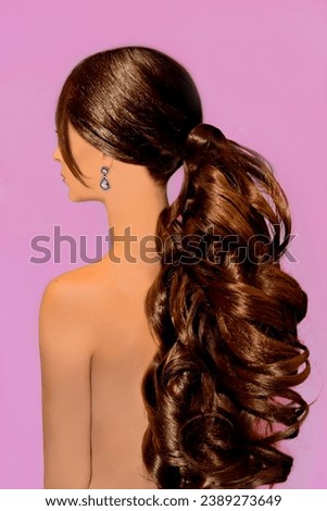 Stunning model with curly Barbie style ponytail