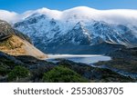 Stunning mountain landscape with clouds covering peaks mt cook new zealand national park winter snow peaks