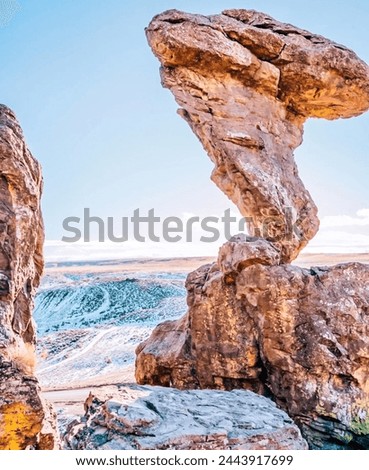 stunning natural rock arch stands against the backdrop of a turbulent ocean under a serene sky. Carved by erosion, this geological wonder showcases nature’s artistry. Tranquil and awe-inspiring, 