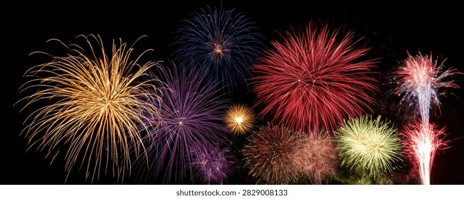 A stunning panorama of colorful fireworks exploding in the dark night sky, creating a festive and celebratory atmosphere.