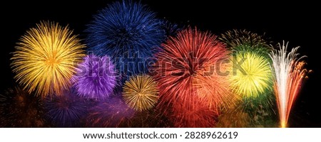 A stunning panorama of colorful fireworks exploding in the dark night sky, creating a festive and celebratory atmosphere.