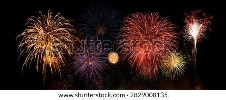 A stunning panorama of colorful fireworks exploding in the dark night sky, creating a festive and celebratory atmosphere.
