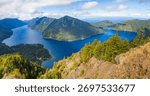 A stunning panoramic view captures the pristine Lake Crescent stretching out below, seen from the summit of the popular Mount Storm King Trail in Olympic National Park, Washington State.