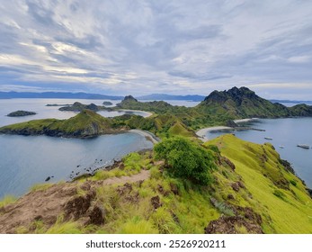 Stunning panoramic view of the Komodo Islands with lush green hills and pristine turquoise waters. A beautiful landscape for your travel, nature, and island-themed projects - Powered by Shutterstock