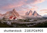 Stunning panoramic view of the Three Peaks of Lavaredo, (Tre cime di Lavaredo) Mount Paterno and a refuge during a beautiful sunset.