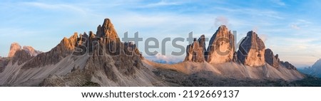Stunning panoramic view of the Three Peaks of Lavaredo (Tre cime di Lavaredo) during a beautiful sunset. The Three Peaks of Lavaredo are the undisputed symbol of the Dolomites, Italy.	