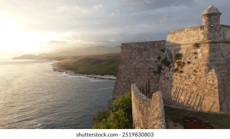 Stunning photo of an ancient fortress overlooking a rugged coastline at sunset. Golden light, crashing waves, and misty distant hills evoke serenity and history. Perfect for travel or nature.

 - Powered by Shutterstock